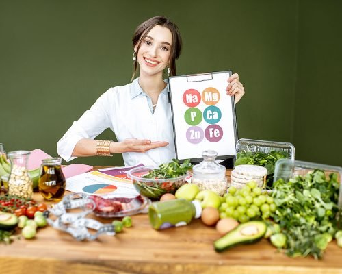 dietitian-with-vitamin-sheme-at-the-table-full-of-resize.jpg